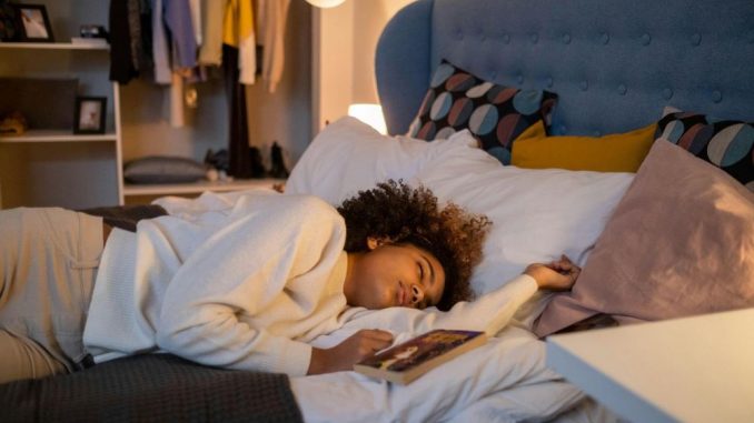 girl sleeping with book